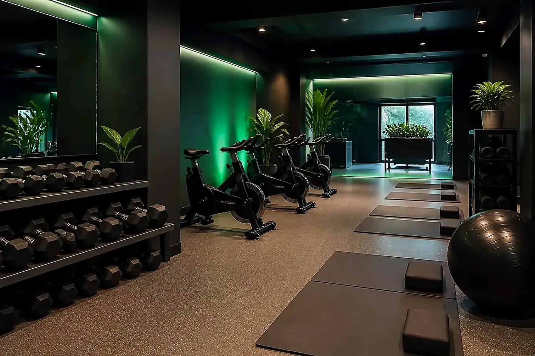 Separate ladies zone with light dumbbells, spin bikes and yoga mats